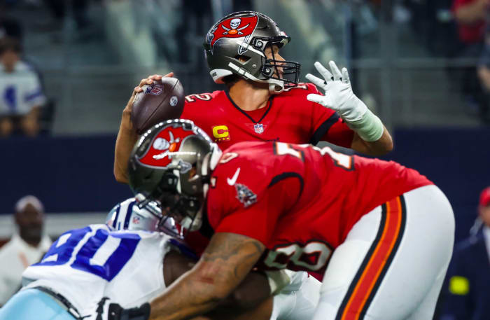 Tom Brady throws as Tampa Bay Buccaneers offensive tackle Tristan Wirfs blocks a Cowboys defensive end